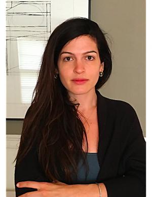 Resnick image Elana Resnick with arms crossed, drawing in the background
